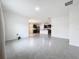 Open concept living room with kitchen access and tile flooring at 2649 Howland Blvd, Deltona, FL 32738