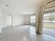 Open living room with tile floors and access to adjacent rooms at 2649 Howland Blvd, Deltona, FL 32738