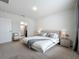 Main bedroom with plush carpet, neutral tones, and en-suite bathroom access at 2649 Howland Blvd, Deltona, FL 32738