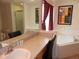 Bathroom featuring a soaking tub, dual vanities, and a glass-enclosed shower at 2803 Lido Key Ct, Kissimmee, FL 34747