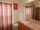 Bathroom featuring vanity with storage, a toilet, a mirror, and themed wall decor at 2803 Lido Key Ct, Kissimmee, FL 34747