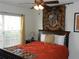 Comfortable bedroom features a cozy bed, natural light from the window, and a ceiling fan at 2803 Lido Key Ct, Kissimmee, FL 34747