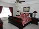 Main bedroom with a king-size sleigh bed, ceiling fan, and plenty of natural light at 2803 Lido Key Ct, Kissimmee, FL 34747
