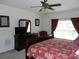 Bedroom with a queen-size bed, dresser, and a ceiling fan at 2803 Lido Key Ct, Kissimmee, FL 34747