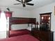 Cozy bedroom with wooden bunk beds, red accents, and a ceiling fan for added comfort at 2803 Lido Key Ct, Kissimmee, FL 34747