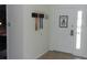 Welcoming entryway with coat rack and door features a sign that reads 