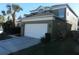 Two-story house with a two-car garage and well-maintained lawn at 2803 Lido Key Ct, Kissimmee, FL 34747