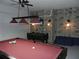 Game room with a pool table, foosball table, and stone accent wall at 2803 Lido Key Ct, Kissimmee, FL 34747