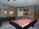 Spacious game room with a pool table, foosball table, stone accent walls, and stylish lighting at 2803 Lido Key Ct, Kissimmee, FL 34747