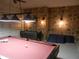 Finished game room with a pool table, foosball table, and unique stone walls at 2803 Lido Key Ct, Kissimmee, FL 34747