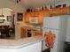 Kitchen and dining area featuring light wood cabinets and white appliances at 2803 Lido Key Ct, Kissimmee, FL 34747