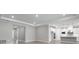 Open living space adjacent to a modern kitchen, featuring wood-look tile flooring and recessed lighting at 2975 Arranmore Dr, Ormond Beach, FL 32174