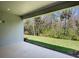 This is a screened patio with a beautiful view of the green lawn and mature trees at 2975 Arranmore Dr, Ormond Beach, FL 32174