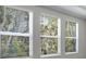 Bright room with three large windows offering ample natural light and serene outdoor views at 2975 Arranmore Dr, Ormond Beach, FL 32174