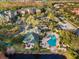 Aerial view of community pool, clubhouse, and surrounding buildings at 3050 Pirates Retreat Ct # 303, Kissimmee, FL 34747