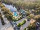 Aerial view of community pool, clubhouse, and landscaping at 3050 Pirates Retreat Ct # 303, Kissimmee, FL 34747