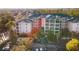Aerial view of three-story building, parking and surrounding landscape at 3050 Pirates Retreat Ct # 303, Kissimmee, FL 34747