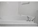Relaxing corner bathtub with updated tile surround and chrome fixtures at 3050 Pirates Retreat Ct # 303, Kissimmee, FL 34747