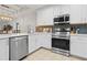 Modern kitchen with white cabinets and stainless steel appliances at 3050 Pirates Retreat Ct # 303, Kissimmee, FL 34747