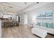 Bright living room with hardwood floors, open concept layout, and modern light fixture at 3050 Pirates Retreat Ct # 303, Kissimmee, FL 34747
