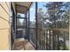 Spacious screened balcony overlooking trees and a parking area at 3050 Pirates Retreat Ct # 303, Kissimmee, FL 34747