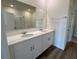 Double vanity bathroom with quartz countertop and large mirror at 3238 Arch Ave, Ormond Beach, FL 32174