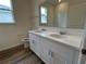 Double sink bathroom with quartz countertops and vinyl flooring at 3238 Arch Ave, Ormond Beach, FL 32174