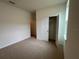 Well-lit bedroom with closet and carpet flooring at 3238 Arch Ave, Ormond Beach, FL 32174