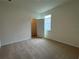 Spacious bedroom with carpeted floors and walk-in closet at 3238 Arch Ave, Ormond Beach, FL 32174