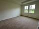 Spacious bedroom with neutral carpet and large windows at 3238 Arch Ave, Ormond Beach, FL 32174