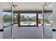 Inviting community pool area with lush greenery, framed by the building's open doorway, creating a serene view at 3238 Arch Ave, Ormond Beach, FL 32174