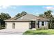 Two-story house with neutral siding, three-car garage, and landscaping at 3238 Arch Ave, Ormond Beach, FL 32174