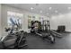 Bright community gym featuring modern equipment and a variety of exercise options with natural light and a sleek black floor at 3238 Arch Ave, Ormond Beach, FL 32174