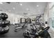 Spacious gym featuring a ceiling fan and multiple workout machines for a full-body workout with natural light from large windows at 3238 Arch Ave, Ormond Beach, FL 32174