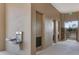 Well-lit hallway with water fountain and exit access, ensuring convenience and safety in the community building at 3238 Arch Ave, Ormond Beach, FL 32174
