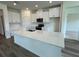 Modern kitchen with white cabinets, quartz countertops, and stainless steel appliances at 3238 Arch Ave, Ormond Beach, FL 32174