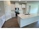 Modern kitchen with white cabinets, quartz countertops, and stainless steel appliances at 3238 Arch Ave, Ormond Beach, FL 32174