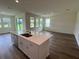 Modern kitchen with island, view into living room, and backyard access at 3238 Arch Ave, Ormond Beach, FL 32174