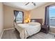 Bright bedroom with wood-look floors, ceiling fan, and ample natural light at 351 Michigan Estates Cir, St Cloud, FL 34769