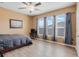 Bedroom with three windows, ceiling fan, and wood-look floors at 351 Michigan Estates Cir, St Cloud, FL 34769