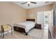 Bright bedroom with a double bed, ceiling fan, and access to a bathroom at 351 Michigan Estates Cir, St Cloud, FL 34769