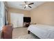 Cozy bedroom with a double bed, ceiling fan, and ample closet space at 351 Michigan Estates Cir, St Cloud, FL 34769