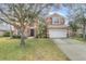 Two-story house with stone accents and a large front yard at 351 Michigan Estates Cir, St Cloud, FL 34769