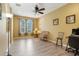 Home office with a ceiling fan and wicker chair at 351 Michigan Estates Cir, St Cloud, FL 34769
