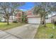 Two-story house with a two car garage and front yard at 351 Michigan Estates Cir, St Cloud, FL 34769