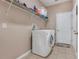 Laundry room with washer, dryer, and overhead shelving at 351 Michigan Estates Cir, St Cloud, FL 34769