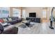 Relaxing living room featuring a leather sectional and a large flat-screen TV at 351 Michigan Estates Cir, St Cloud, FL 34769