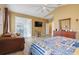 Comfortable main bedroom with king bed and sliding doors to the patio at 351 Michigan Estates Cir, St Cloud, FL 34769