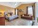 Large main bedroom with high ceiling, king bed, and a sitting area at 351 Michigan Estates Cir, St Cloud, FL 34769