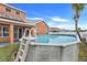 Above ground pool with ladder in the backyard of the house at 351 Michigan Estates Cir, St Cloud, FL 34769